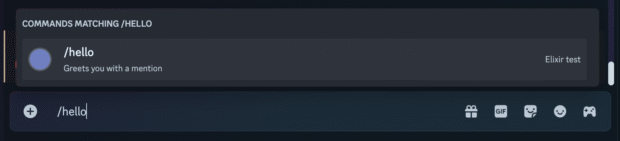 Screenshot of a Discord chat interface showing the slash command input. The user has typed /hello, and the suggestion box displays a matching command titled /hello with the description “Greets you with a mention.” The command is associated with the bot named “Elixir test.”